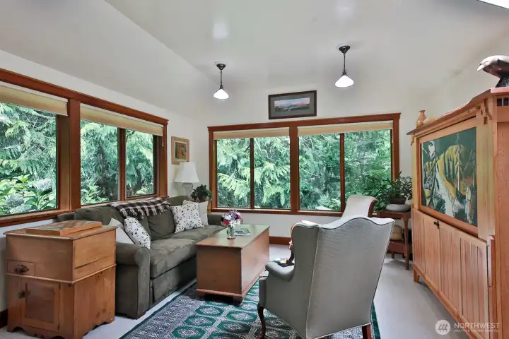 Lots of windows and skylights bring in plenty of light to the Family Room. This part of the home (north side) has you close to the cedars and firs keeping your connection to nature.