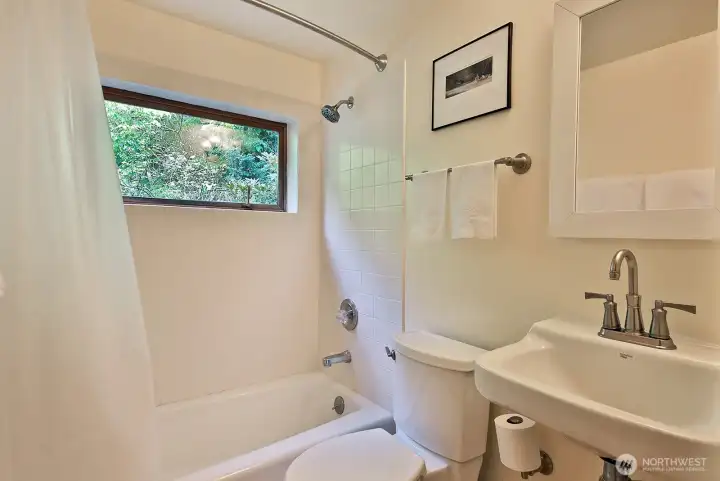 This full bath is located in the hallway between the Kitchen/Dining area and the Family Room. We are now going back to the south/east side of your home, to the mud/laundry room in the next photo.