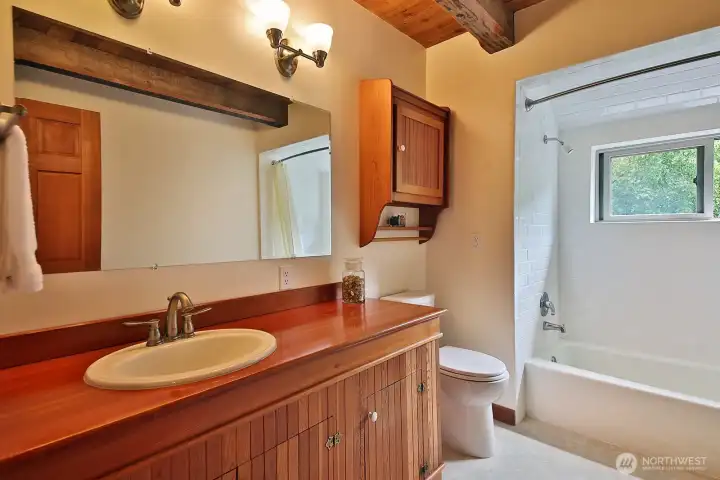Full bath off the hallway between the Primary and Bedrooms #2 & #3.