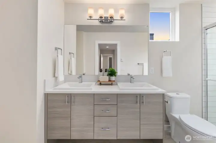 Primary ensuite bathroom with featured trough sink, and walk in tiled shower.