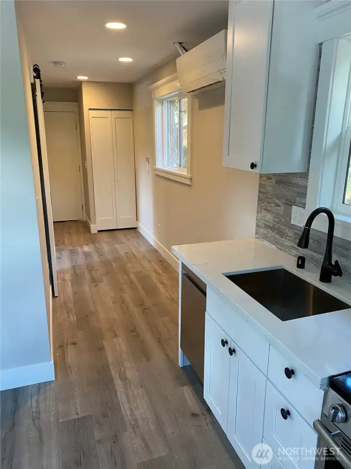 Looking back toward the Laundry Closet with unitized stacked w/d