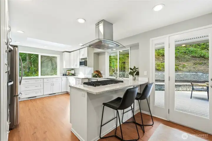 Open Concept Kitchen with Island Cooktop and Direct Access to Private Backyard Deck