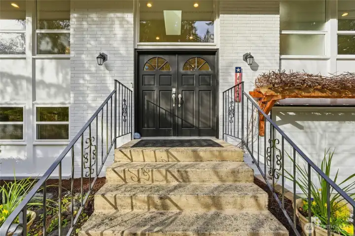 Double Door Front Entry with Brick Exterior and Covered Porch
