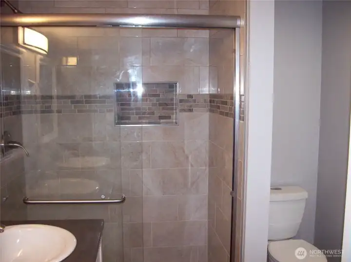 Large shower with plenty of room, with glass doors