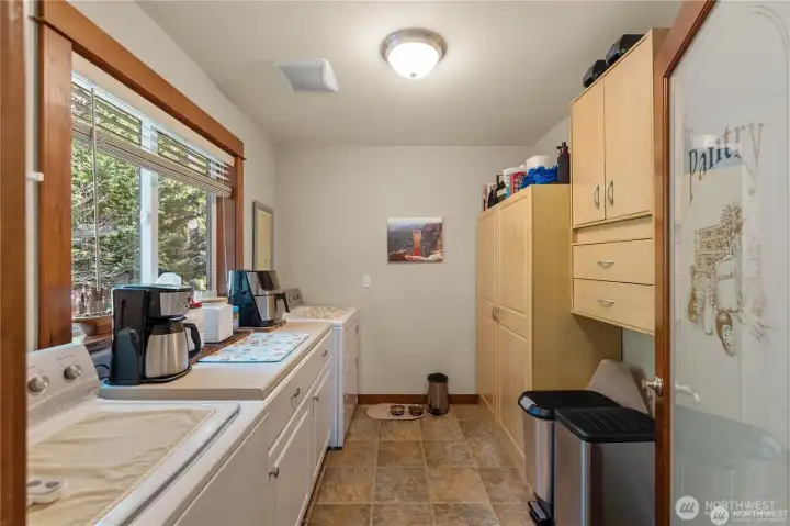 large laundry room - with an upright freezer out of view behind the door