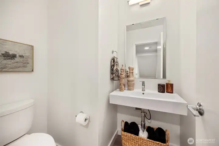 The powder room is in the perfect location.Discreetly tucked away at the top of the stairs on the upper/main floor.