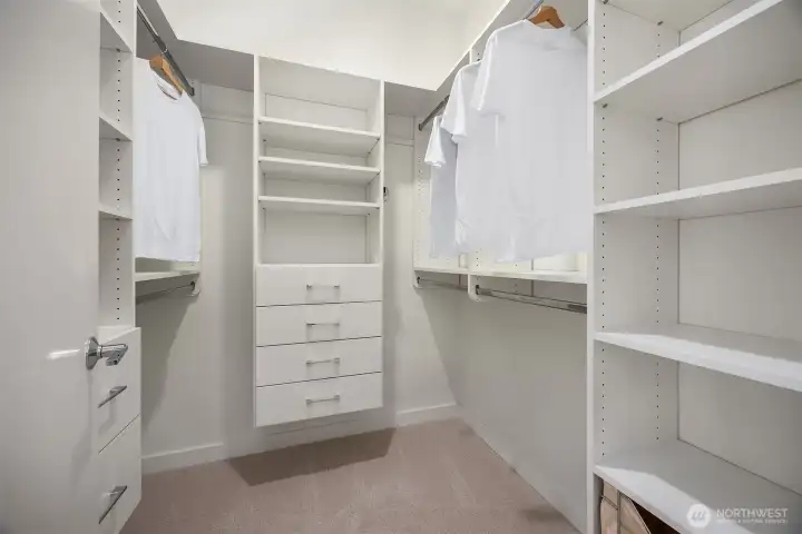 Primary bedroom has custom closet system for efficiently maximizing space.