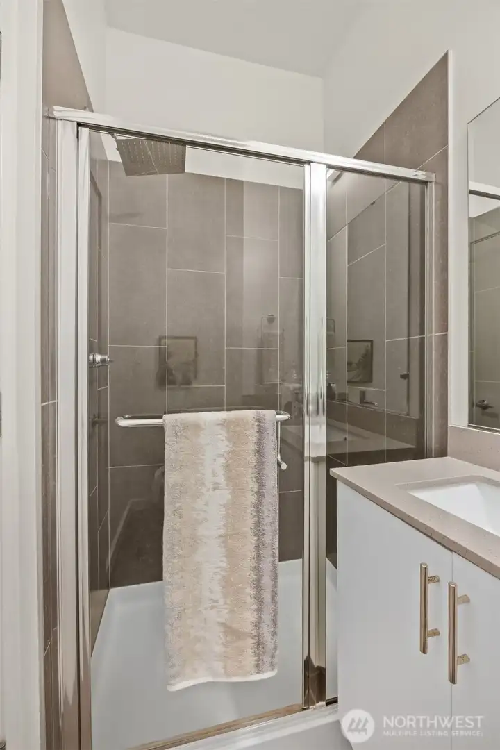 Primary shower with tile surround.