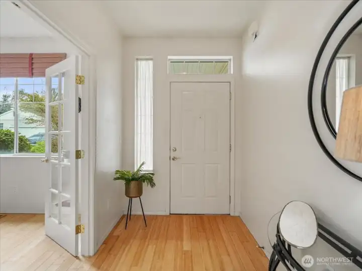 Inviting entryway with rich Bamboo hardwoods flowing into the den and kitchen, creating a warm and cohesive feel.
