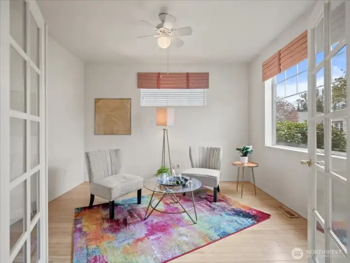 Additional view of the den highlighting its generous space and ceiling fan, perfect for relaxing or entertaining.