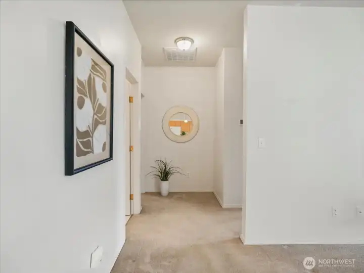 Thoughtfully designed hallway connecting the bedroom spaces with a stylish full guest bathroom.