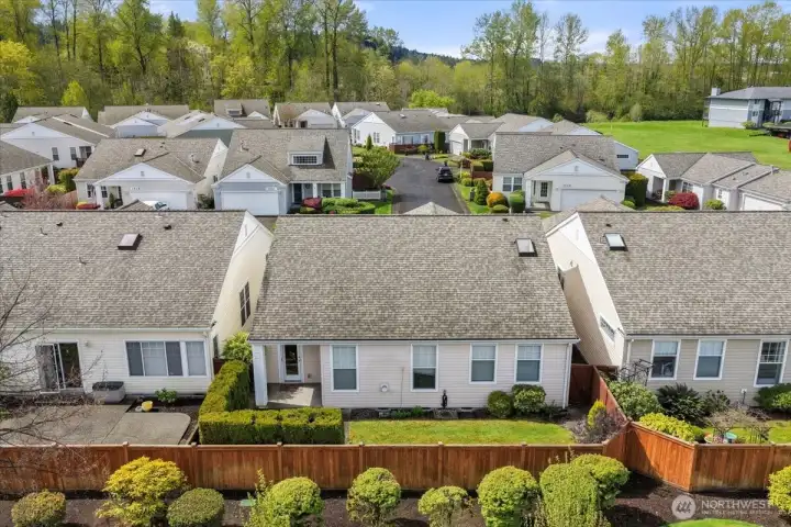 Aerial perspective emphasizing the secluded feel, patio area, and easy care yard.