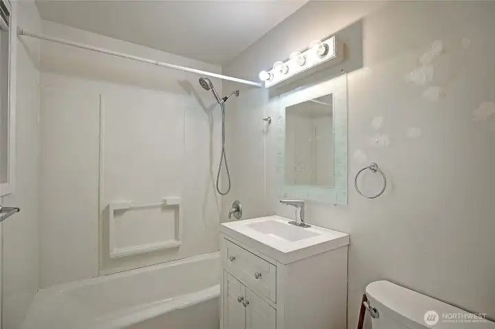Full bathroom featuring a tub/shower combo and functional layout.