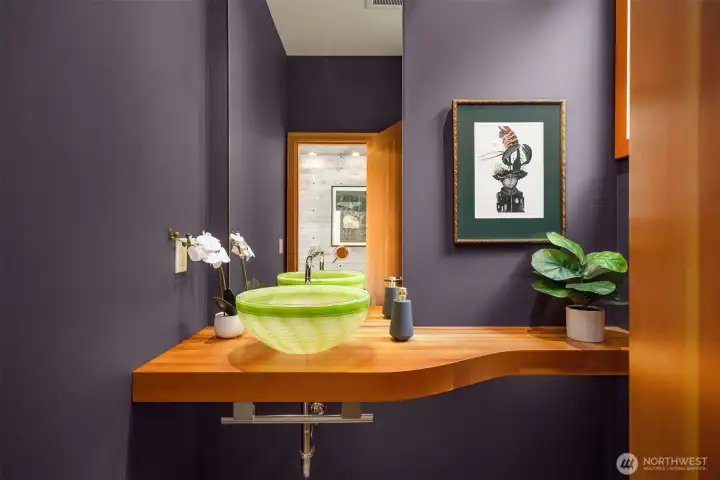 One of two powder rooms on the main floor features a one-of-a-kind blown glass sink.