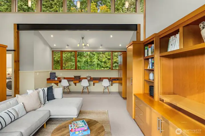 Custom built-ins include a multi-user desk in the media/family room.