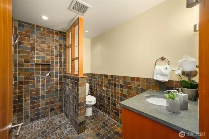 3/4 bath with curbless entry shower and slate finishes.