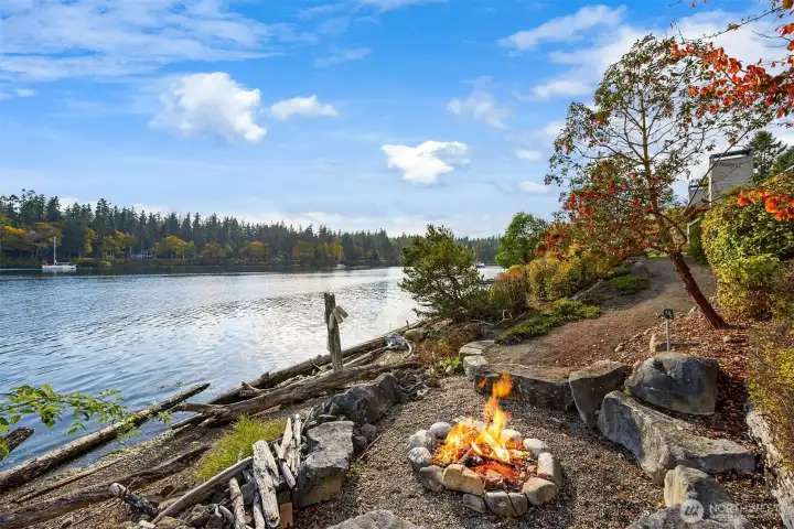 Follow the pathway on the east side of the property to a fire pit at the shore.