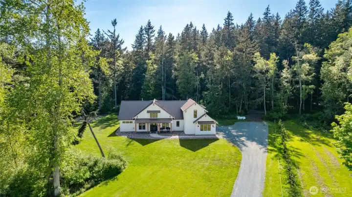 Dream home in picturesque setting on 5 acres.