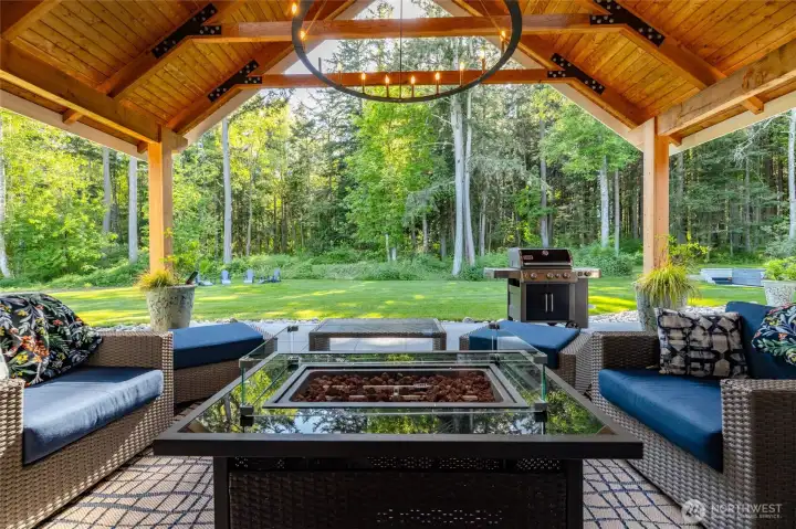 Enjoy outdoor entertaining year around with this gorgeous covered patio offering wood ceilings, a large chandelier and plumbed for propane heaters.