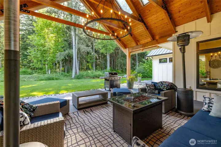 Covered tile patio with skylights for added light, wood beams, beautiful chandelier and plumbed for propane heaters. Perfect for entertaining outside rain or shine!