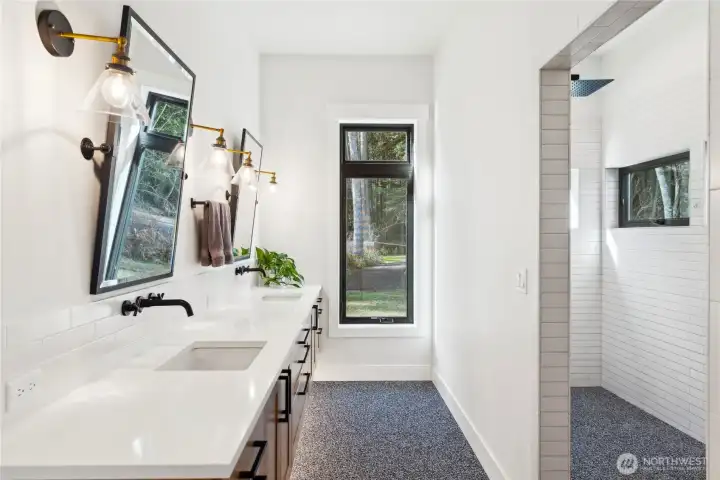 Primary ensuite bathroom with heated floors, floating double sink vanity and zero entry walk-in shower with heated floors and towel bar.