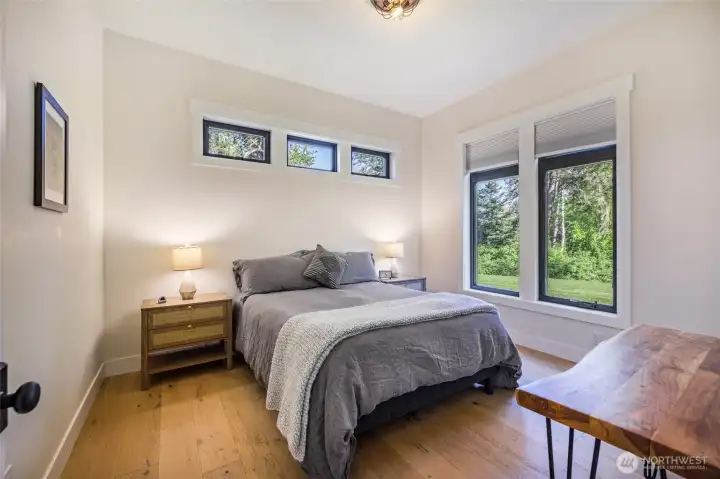 3rd Guest bedroom with wood floors and walk-in closet.