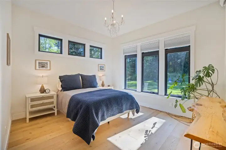 Guest bedroom overlooking the pristine backyard. This room has an ensuite bathroom and walk-in closet.