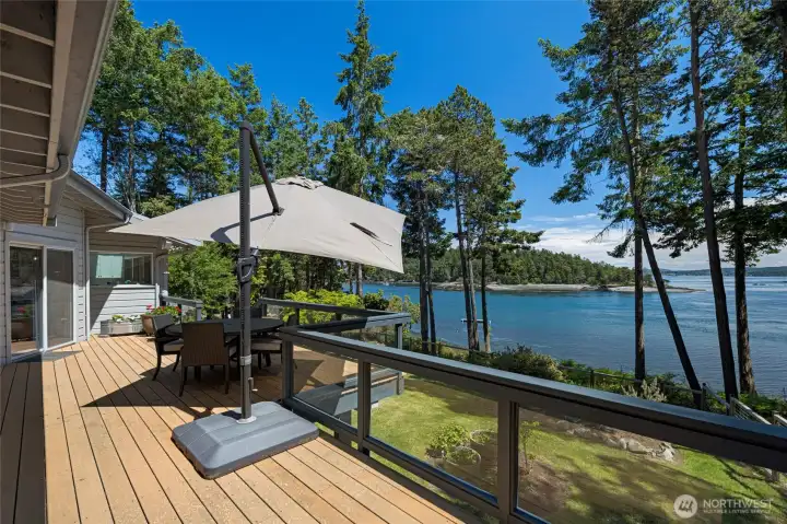 Elevated deck captures beautiful San Juan Island water views through the evergreens, creating an ideal outdoor space for morning coffee, evening sunsets, and island entertaining.