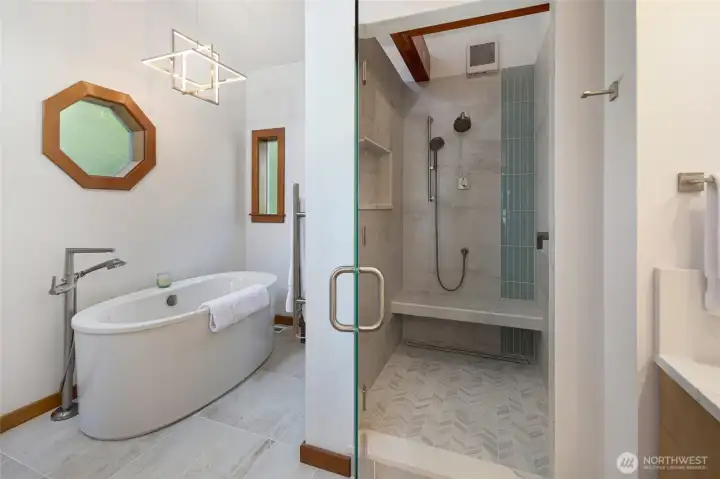 Remodeled ensuite bath includes a freestanding soaking tub, glass-enclosed tile shower, modern fixtures, and spa-inspired finishes for a fresh island retreat feel.