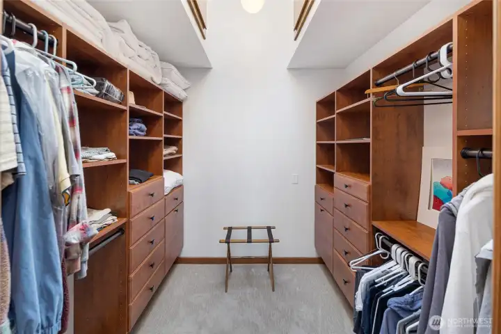 Spacious walk-in closet with custom built-in shelving, drawers, and hanging space, offering excellent storage within the home’s comfortable waterfront layout.