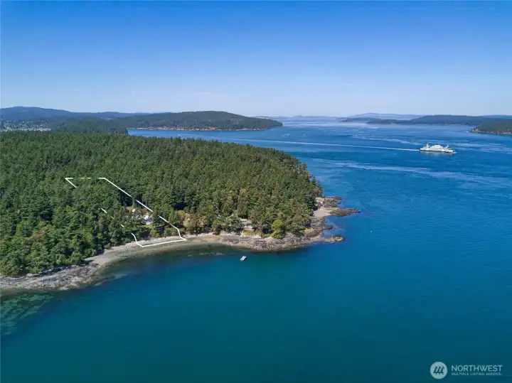 Aerial parcel view highlights the 1.08± acre waterfront setting, mature trees, beach access, and private location just minutes from the shops, dining, and amenities of Friday Harbor.