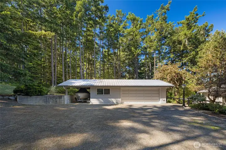 Detached garage with additional covered storage offers excellent functionality for vehicles, tools, kayaks, boating gear, or island lifestyle equipment.