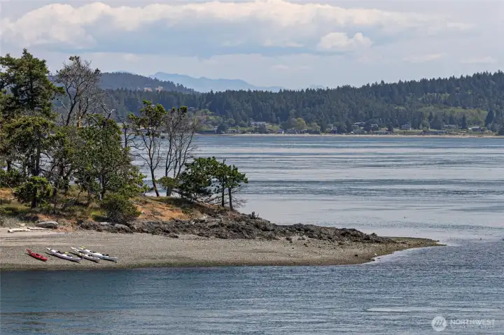 Scenic water views across the channel toward nearby islands, capturing the outdoor recreation opportunities and waterfront lifestyle that make San Juan Island living so desirable.