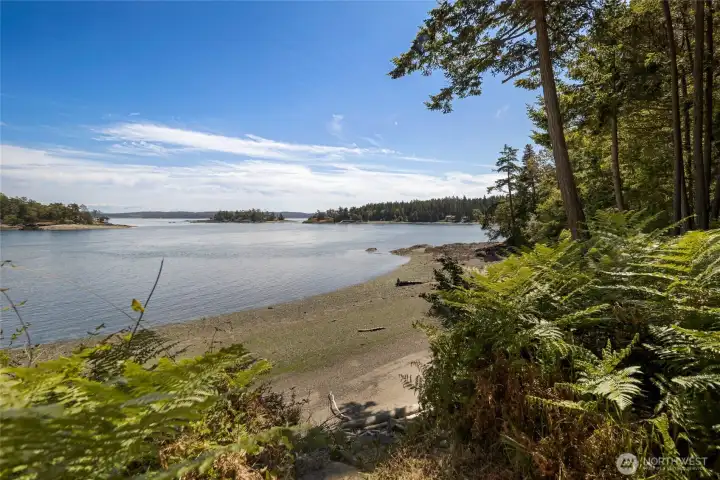 Sheltered cove views capture the calm waterfront setting, nearby islands, and natural shoreline, ideal for kayaking, wildlife watching, and enjoying San Juan Island scenery.