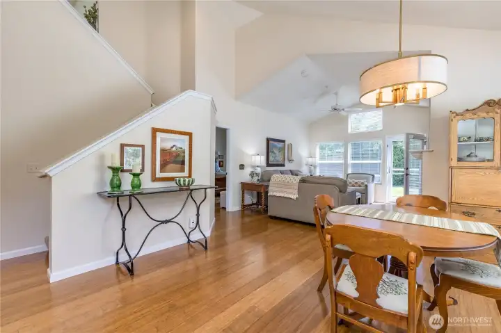 Bright open floor plan with soaring ceilings, grounded by gorgeous and durable bamboo flooring.