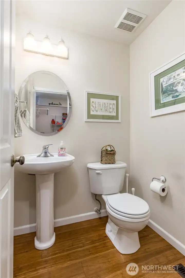 Main floor powder room located just across from the laundry space.
