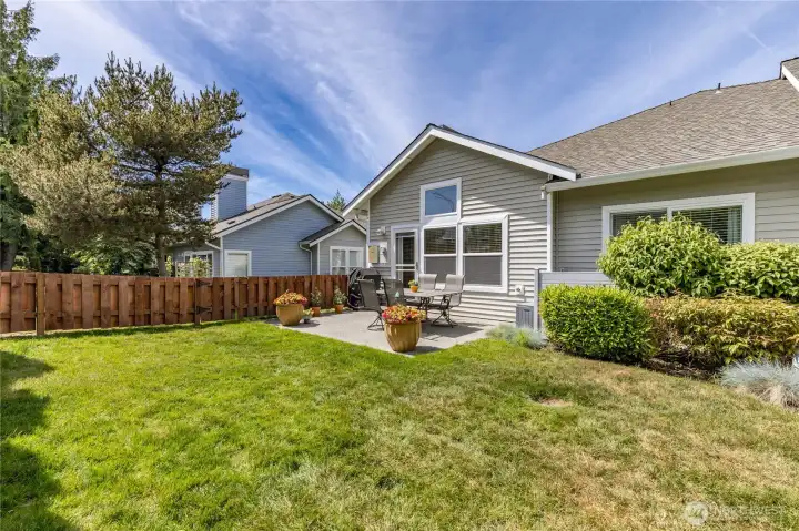 The level, fully-fenced yard offers plenty of space for pets, gardening, or outdoor relaxation.