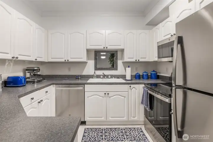 Kitchen features white cabinets and stainless steel appliances Kitchen features white cabinets and stainless steel appliances