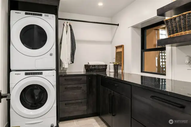 A spacious laundry room that features same high-end finishes as kitchen.