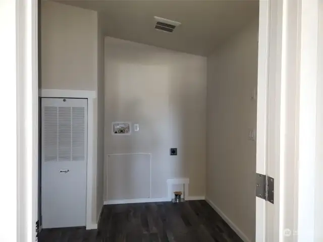 Laundry room with extra storage space off kitchen.