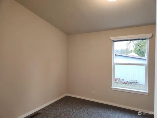 Bedroom #1 with carpet and vaulted ceiling.