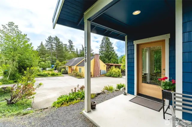 Front door with view of common house and parking