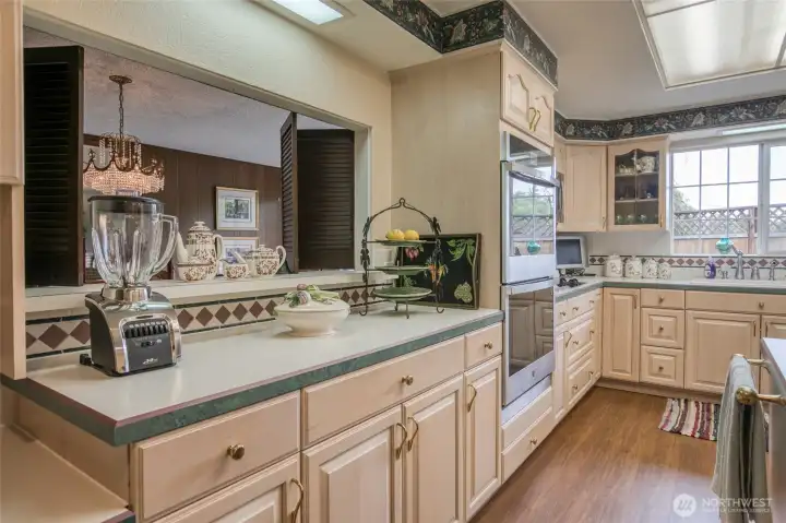 Pass-through window with counter space on kitchen side to dining room.
