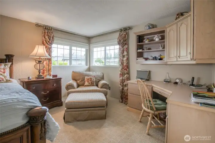 Primary bedroom with spacious desk with a large work surface and multiple drawers.