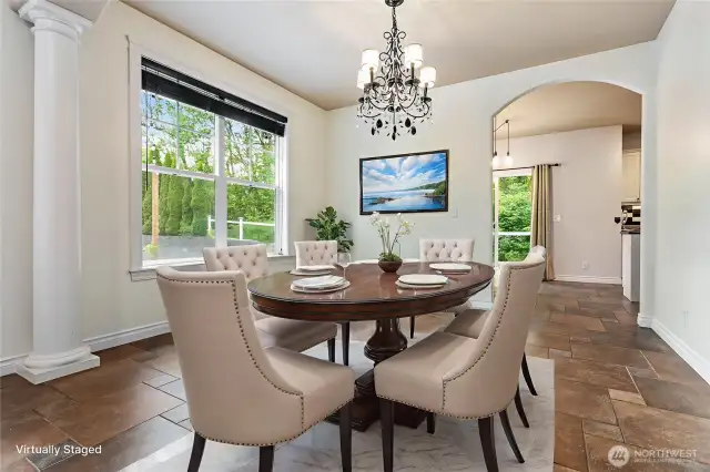 Stepping out of the kitchen, you'll find a formal dining space bathed in natural light. Virtually staged.
