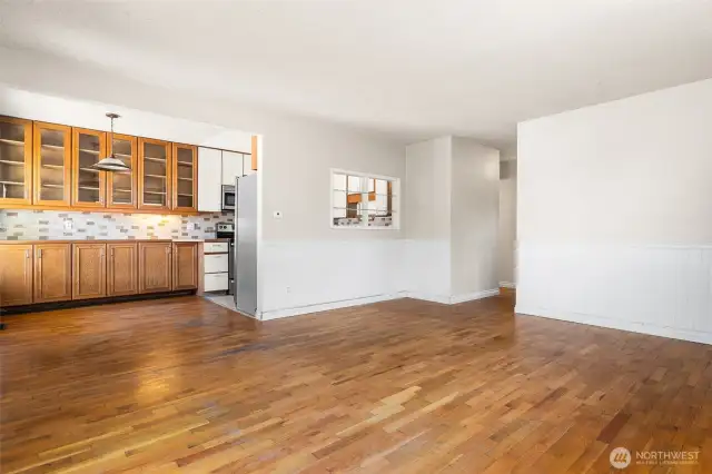 This is the formal living room and dining area as you enter.  The hallway leads to the three bedrooms - kitchen is just past the wall of glass front cabinets in the dining area.