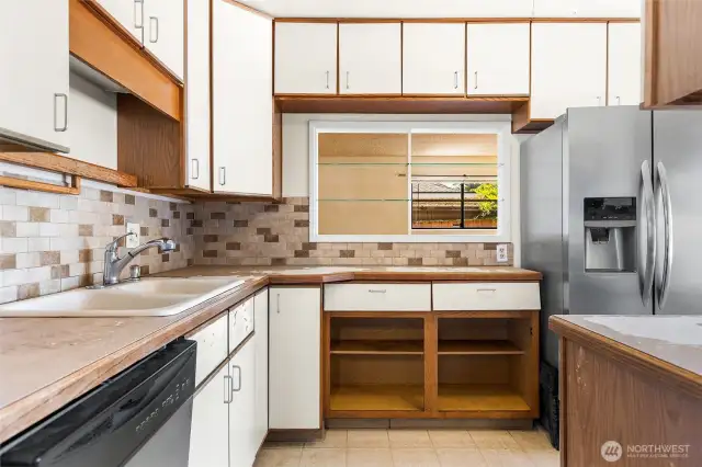 Opposite angle of the kitchen shows the pass through to the living room