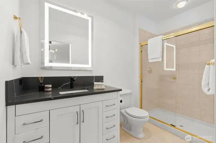 Primary Bath has updated vanity, fixtures, mirror