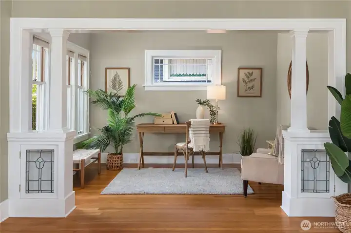 A versatile flex space off the living room doubles as a home office or cozy reading corner, framed by custom millwork.