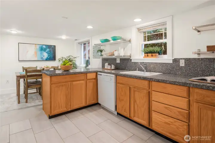 This open-concept layout connects kitchen and dining seamlessly, creating a welcoming space for gatherings or independent living.
